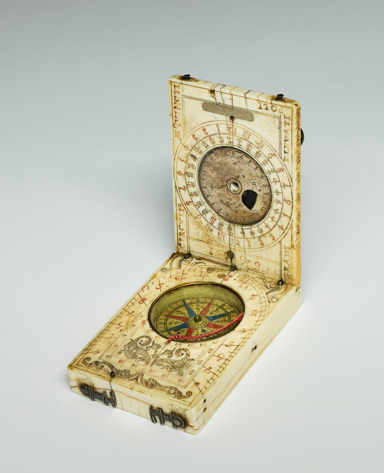 Open folding portable sundial with compass and engraved scales, made of ivory and silver, anonymous, c. 1590.