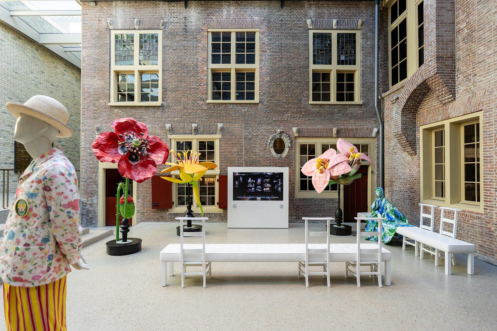 Courtyard of Museum De Lakenhal with monumental flowers, mannequins and seating as part of the presentation of Garden of Delights.