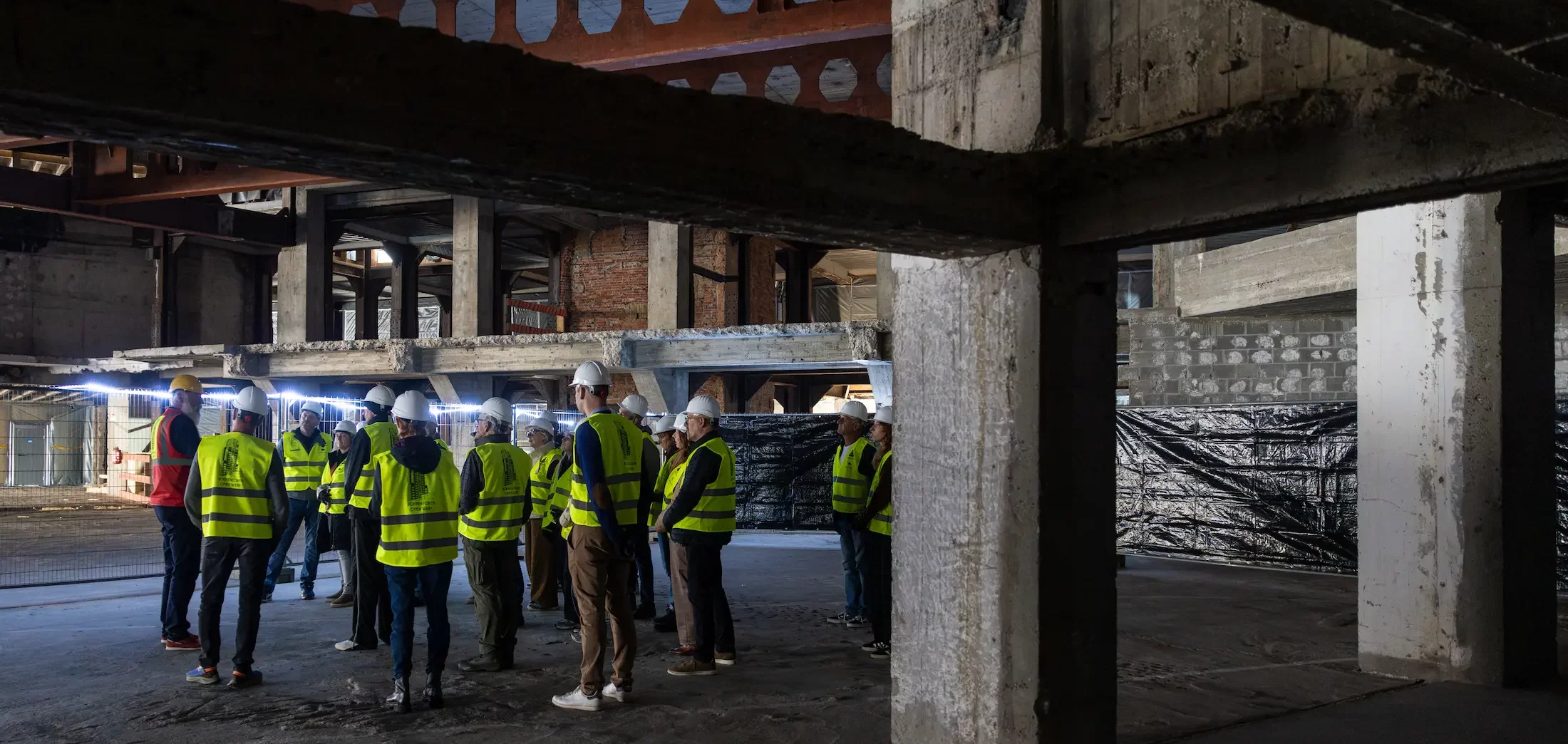 Visitors on a guided tour inside the Boerentoren in Antwerp during the building’s transformation.