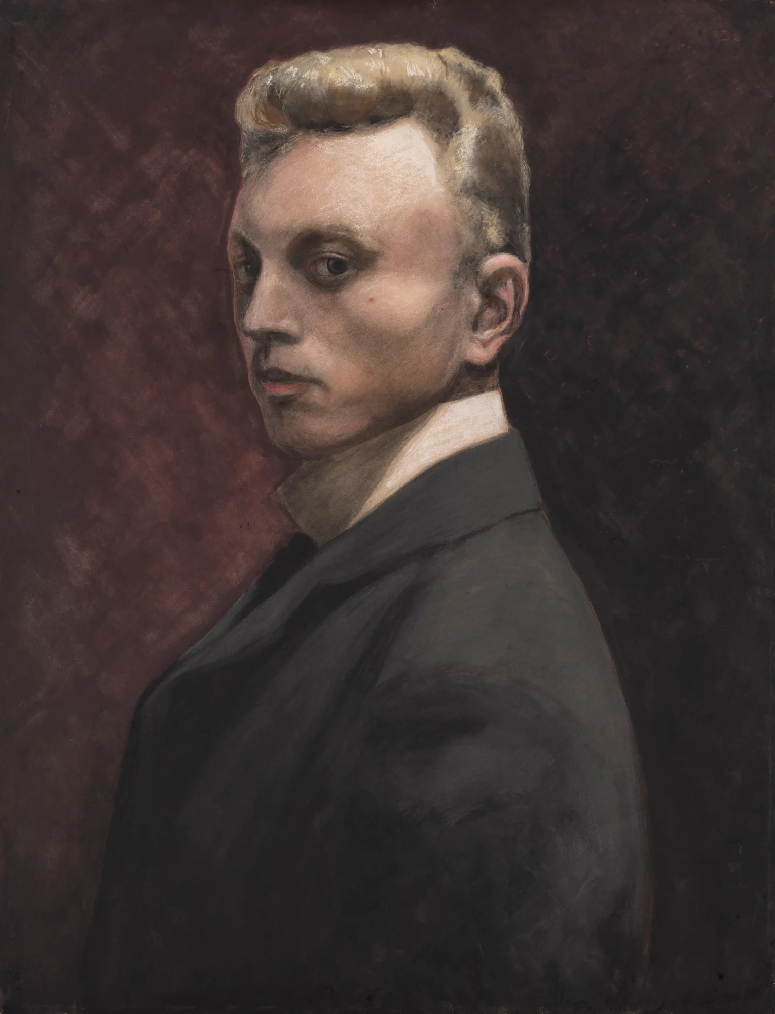 Self-portrait by Léon Spilliaert showing the artist in dark clothing, turned partly towards the viewer against a deep reddish-brown background.